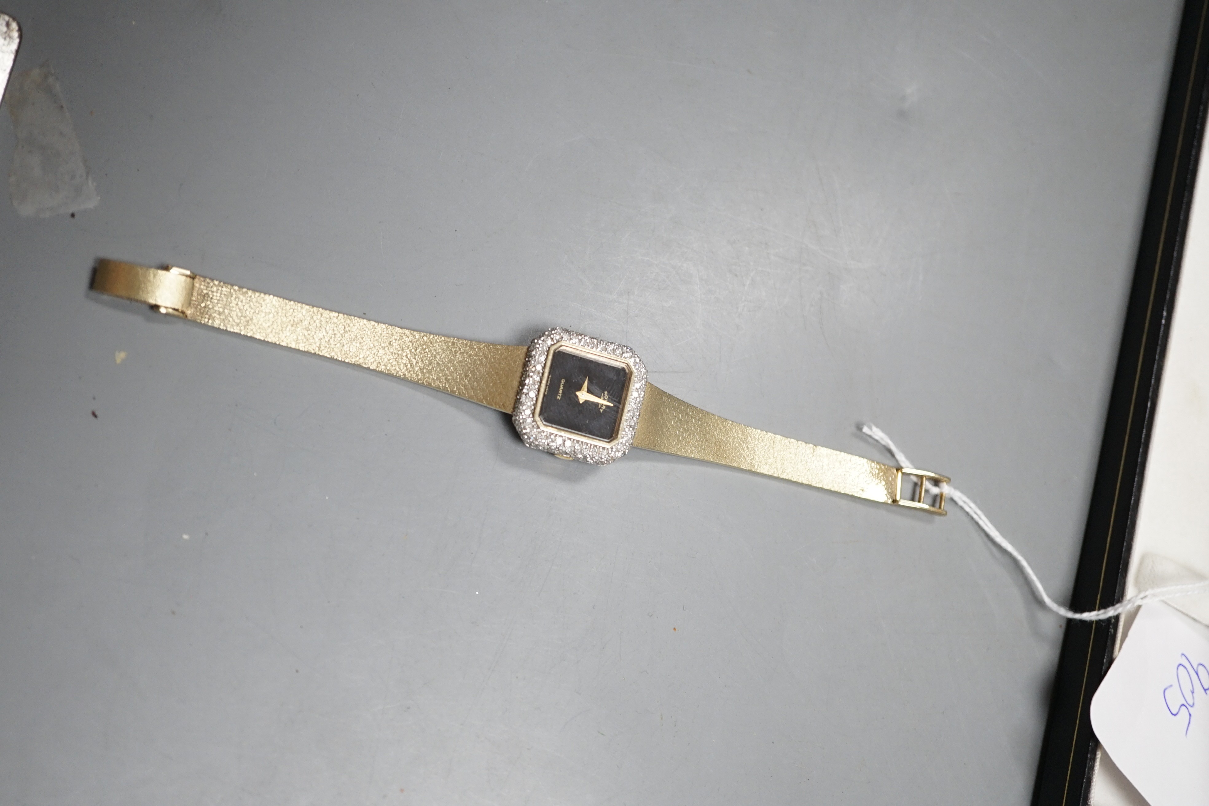 A lady's 9ct gold and diamond set quartz wrist watch, overall length 17.2cm, gross weight 33.3 grams, on 9ct gold strap.